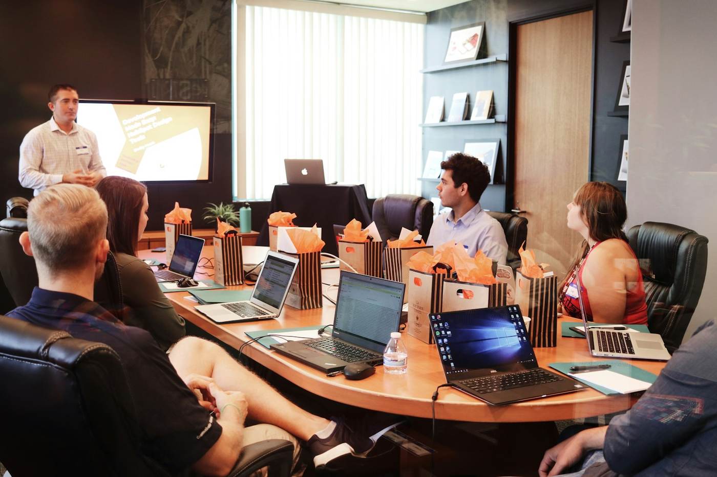 A product team reviewing work together in a meeting room